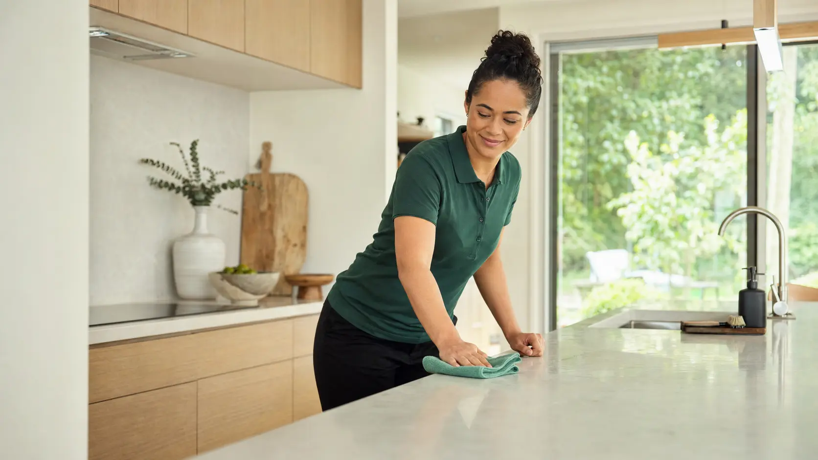 Professional Purehome cleaner caring for a modern Auckland kitchen